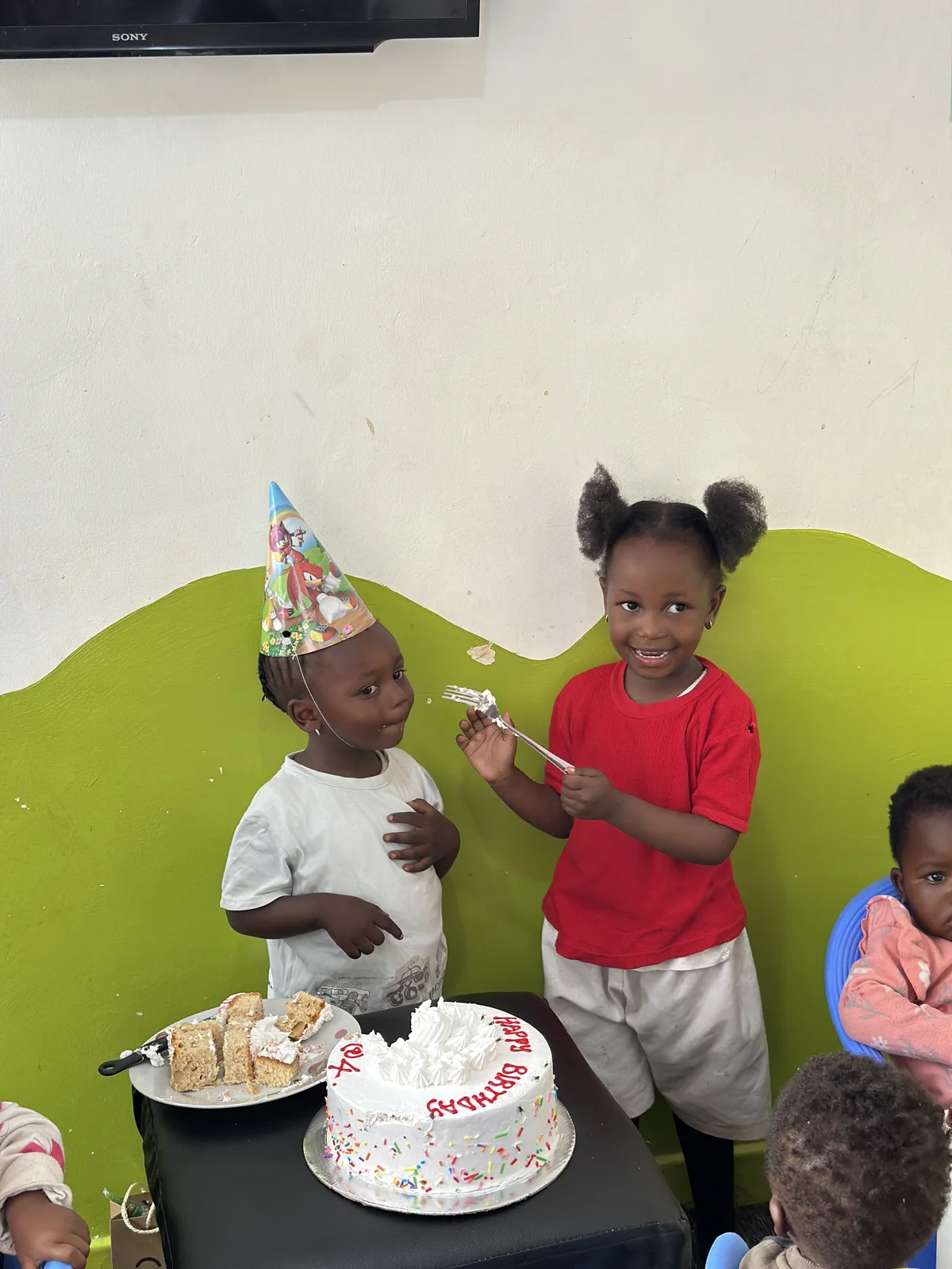 Two children celebrating a birthday together