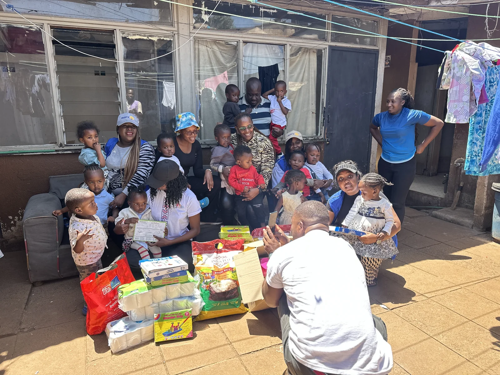 A wider community gathering outside Little Heaven