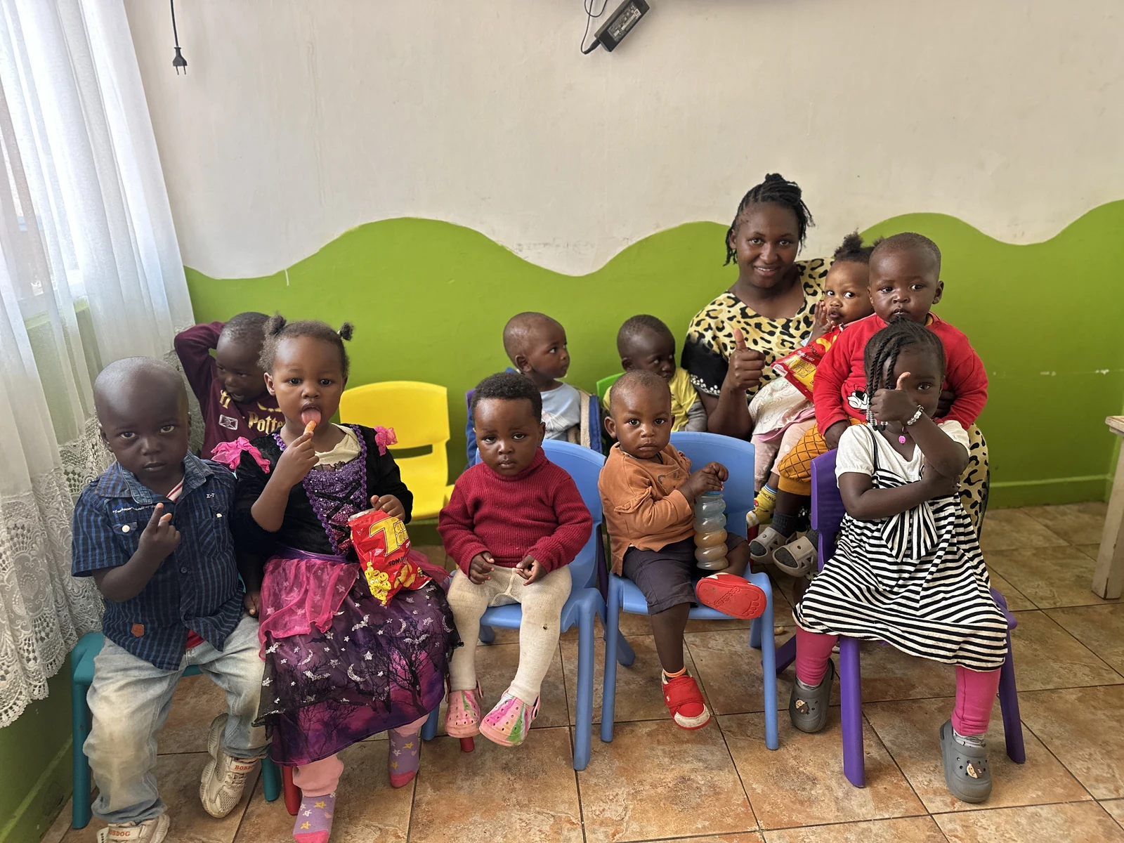 Children and a caregiver gathered together at Little Heaven